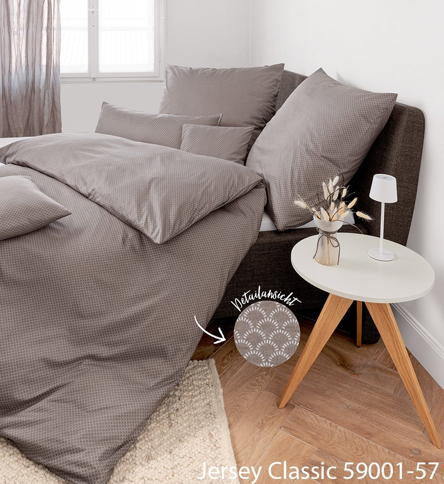 Janine Jersey Classic Interlock-Jersey Bettwäsche in einem Grauton mit feinem Muster auf einem Bett